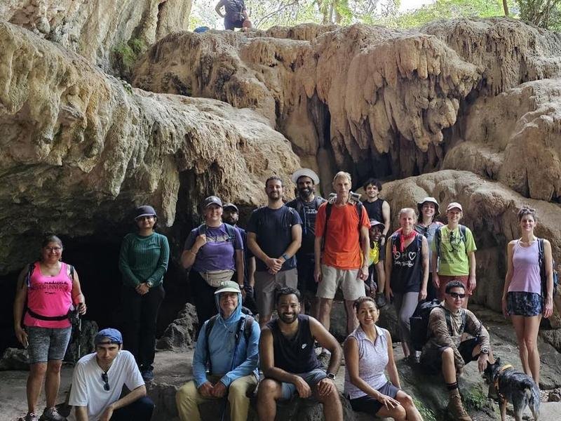 A Wander and Hike group under a rock overhang at Reimers Ranch, Texas